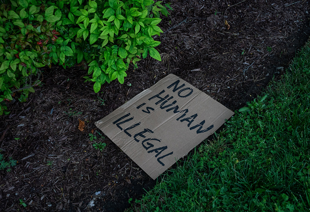 A sign lies on the ground after a bus with detained people left the Department of Homeland Security field office in Nashville where multiple immigrant rights groups gathered to protest what they believe to be a multi-agency operation to detain-noncitizens overnight in Nashville, Tenn., May 4, 2025. (OSV News/Reuters/Seth Herald)