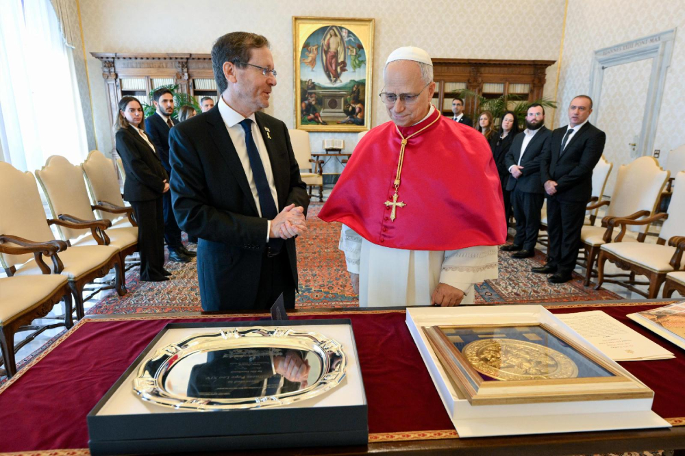 Pope Leo XIV and Israeli President Isaac Herzog exchange gifts at the end of their meeting in the library of the Apostolic Palace at the Vatican Sept. 4, 2025. (CNS/Vatican Media)