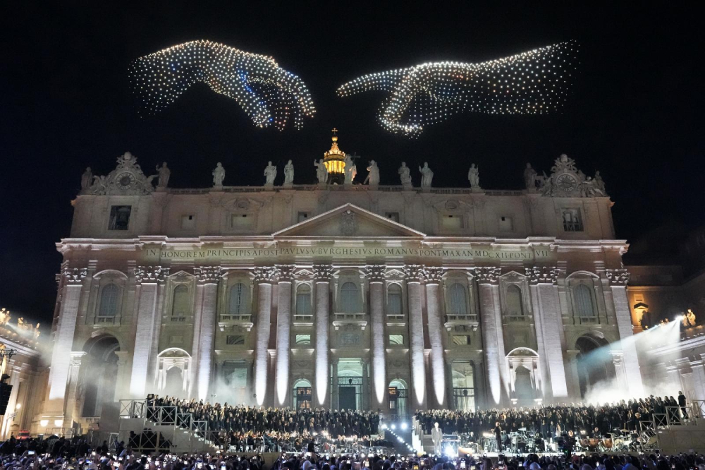 The finger of Adam and the finger of God from the creation scene in Michelangelo's ceiling fresco in the Sistine Chapel is recreated by drones flying over St. Peter's Basilica at the Vatican Sept. 13, 2025, during the concert, "Grace for the World," which concluded the World Meeting on Human Fraternity. (CNS/Lola Gomez)