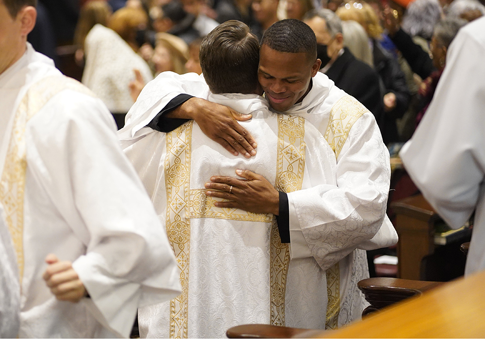 Callistus Ibeh, right, exchanges the sign of peace with fellow Diocese of Brooklyn, New York, seminarian Juan Herrera-Posada during their ordination to the transitional diaconate at St. Joseph's Seminary in Yonkers, New York., Nov. 9, 2024. (OSV News/Gregory A. Shemitz)