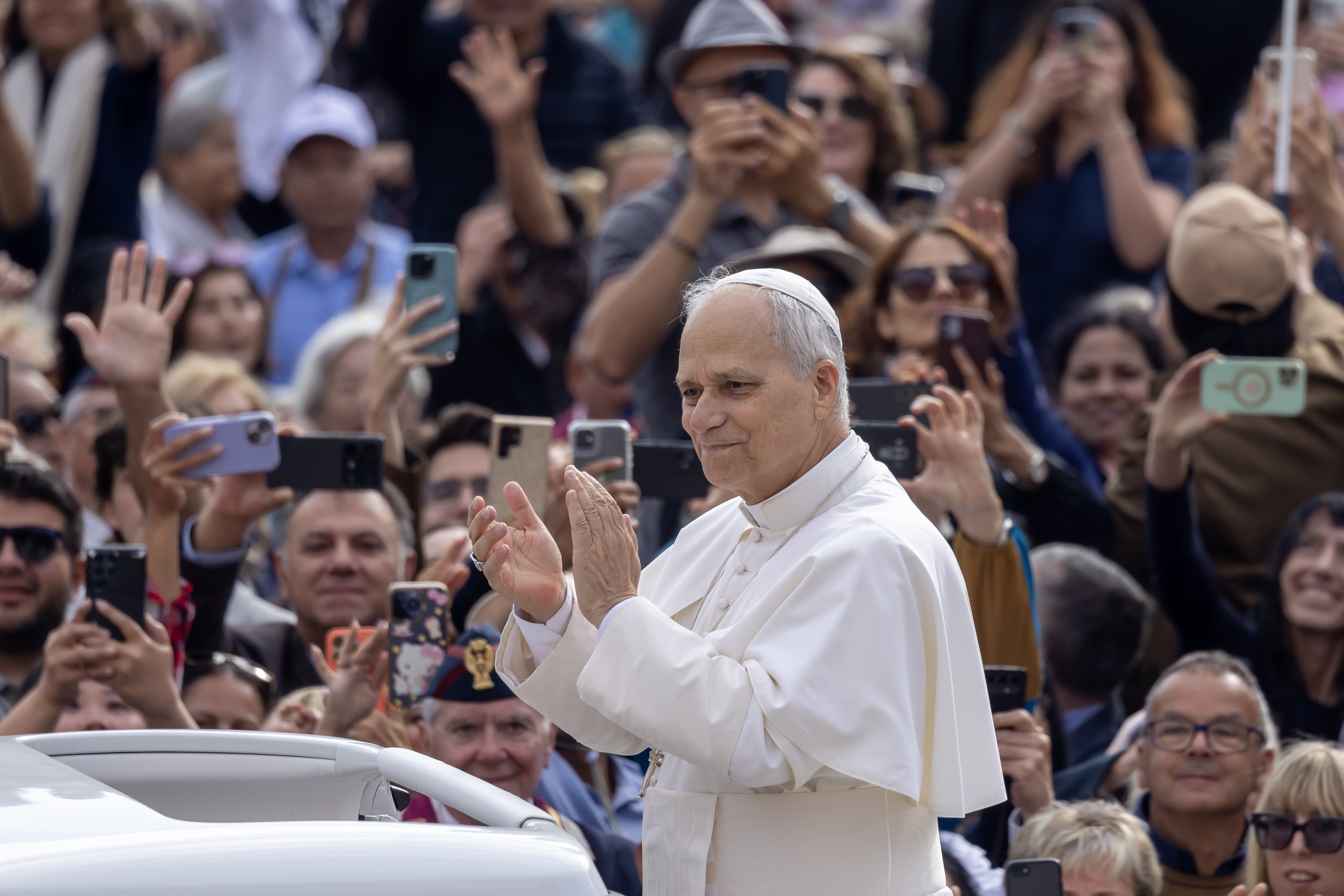 Pope Leo XIV applauds as he greets visitors and pilgrims from the popemobile before his weekly general audience in St. Peter's Square at the Vatican Oct. 1, 2025. (CNS photo/Pablo Esparza)