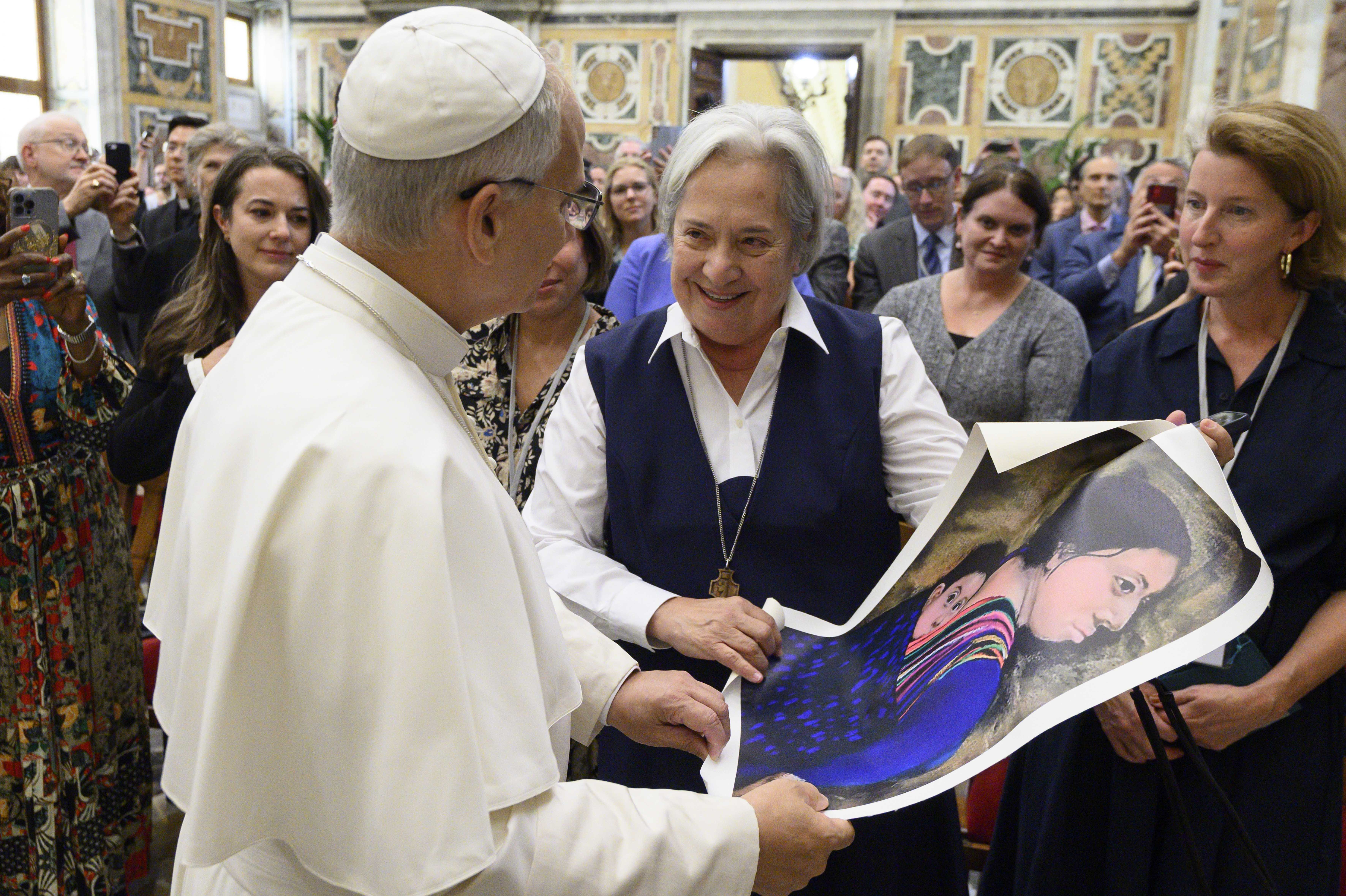 Pope Leo XIV receives a painting from Sister Norma Pimentel, an artist, a Missionary of Jesus and executive director of Catholic Charities of the Rio Grande Valley in Brownsville, Texas, during an audience at the Vatican Oct. 2, 2025. (CNS photo/Vatican Media)