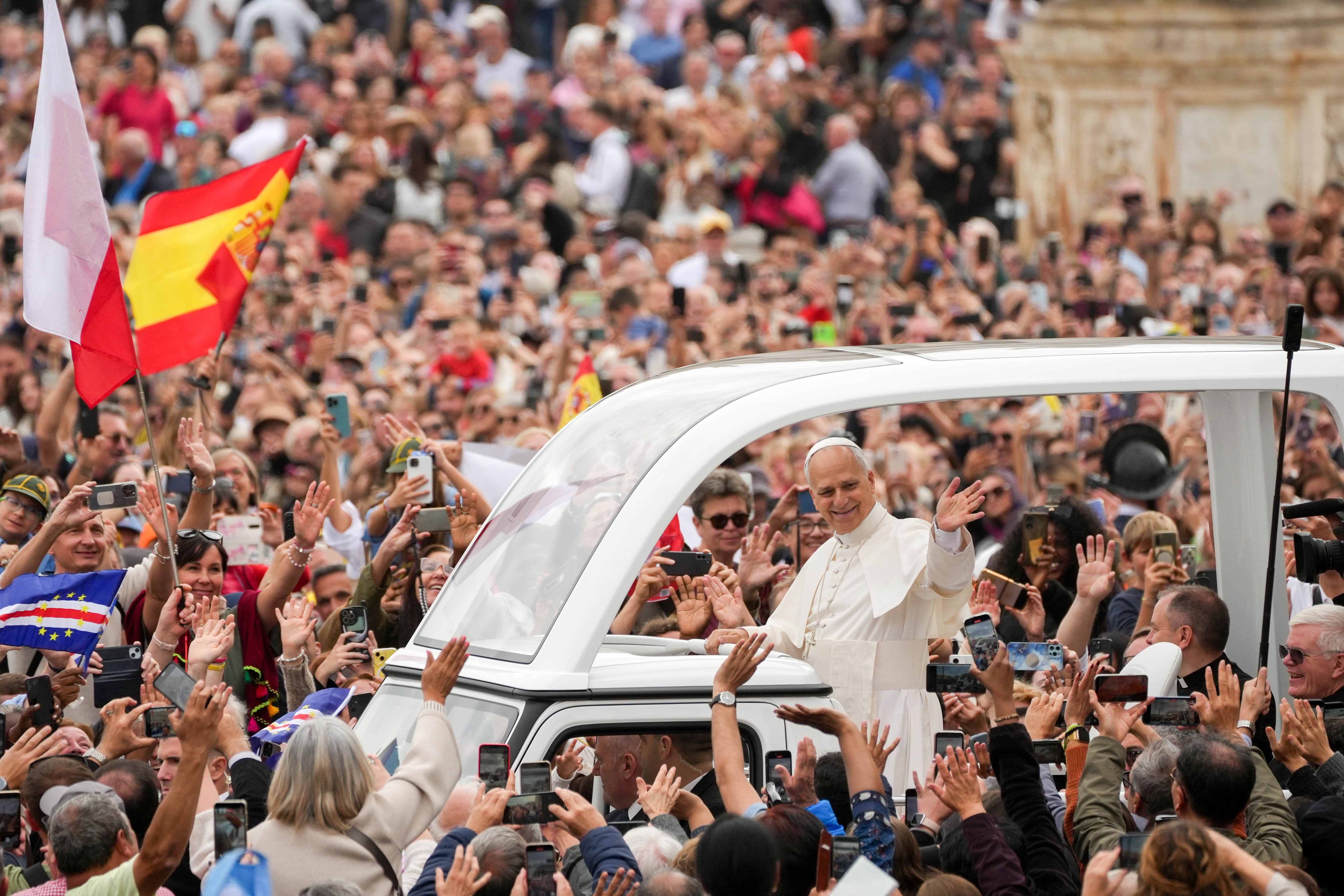 Pope Leo XIV greets people from the popemobile as he rides around St. Peter’s Square following Mass for the Jubilee of Migrants and the Jubilee of the Missions in St. Peter’s Square at the Vatican Oct. 5, 2025. (CNS photo/Lola Gomez)