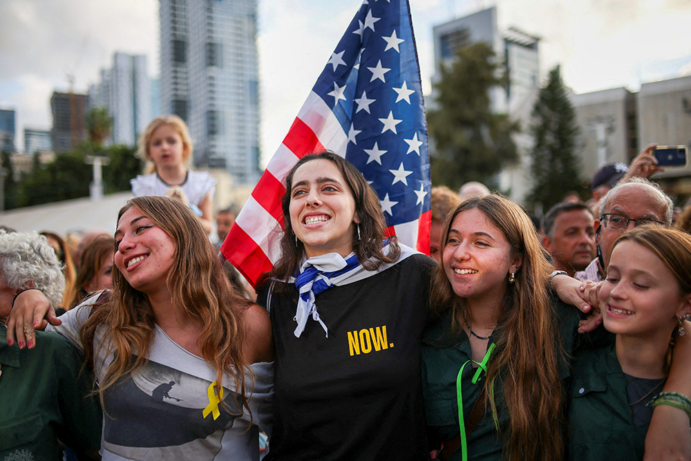 Young women embrace as people gather at Hostage Square in Tel Aviv, Israel, to celebrate after U.S. President Donald Trump announced that Israel and Hamas agreed on the first phase of a Gaza ceasefire Oct. 9, 2025. (OSV News/Reuters/Shir Torem)