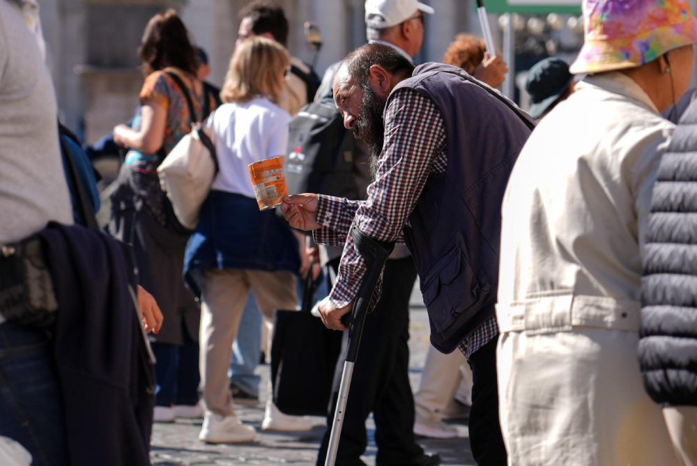 A person asks for alms near St. Peter’s Square at the Vatican Oct. 8, 2025. (CNS/Lola Gomez)