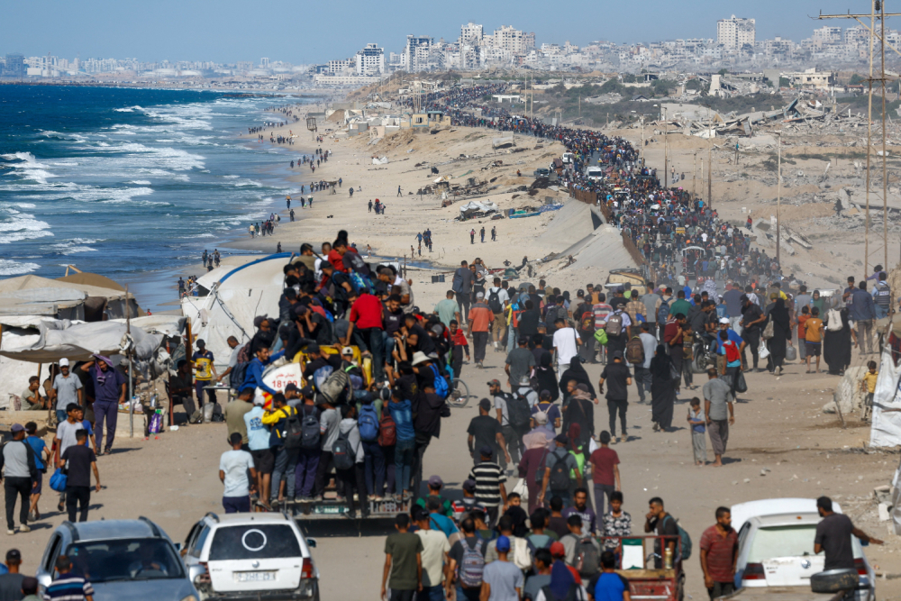 Palestinians, who were displaced to the southern part of Gaza at Israel's order during the war, make their way along a road in the central Gaza Strip as they return to the north Oct. 10, 2025, after a ceasefire between Israel and Hamas in Gaza went into effect. (OSV News/Reuters/Mahmoud Issa)