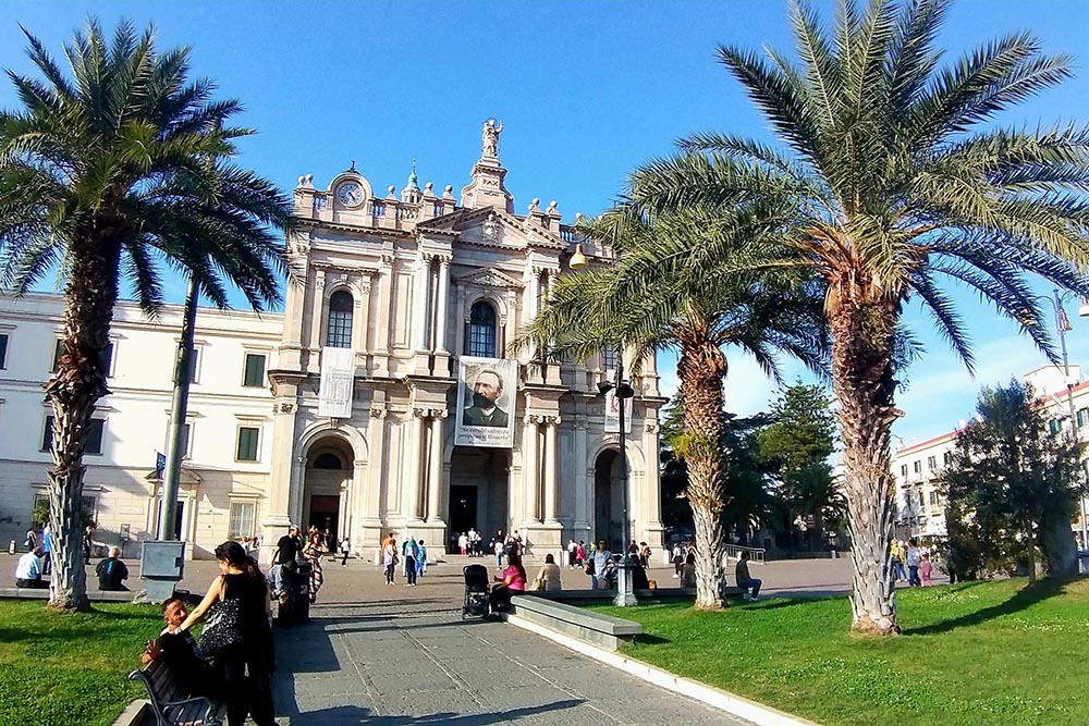 The Shrine of the Blessed Virgin of the Rosary of Pompeii in Italy. A portrait of Bartolo Longo, founder of the shrine, is seen on a banner above the entrance. (Wikimedia Commons/Dina Benedetto Ferrandina)