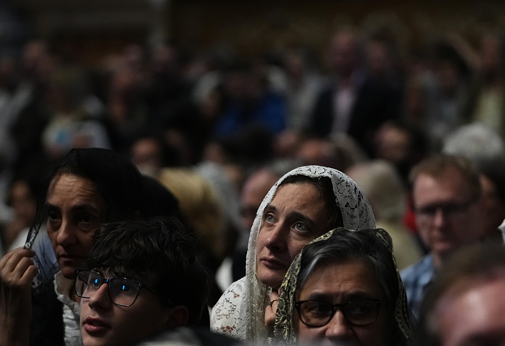 A woman attends a mass celebrated by Cardinal Raymond Burke in St. Peter's Basilica, at the Vatican, Oct. 25, 2025. (AP photo/Alessandra Tarantino)