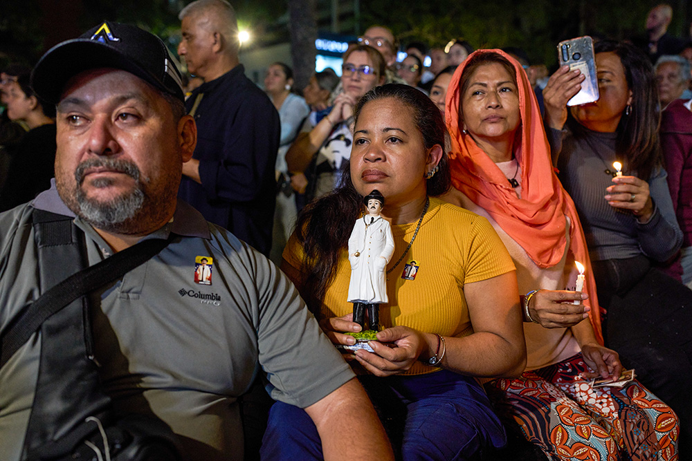 Believers watch the canonization ceremony of José Gregorio Hernández and Mother Carmen Rendiles Martínez by Pope Leo XIV during an event to celebrate Venezuela's first saints at a square in Caracas, Venezuela, Oct. 19, 2025. (AP/Ariana Cubillos)
