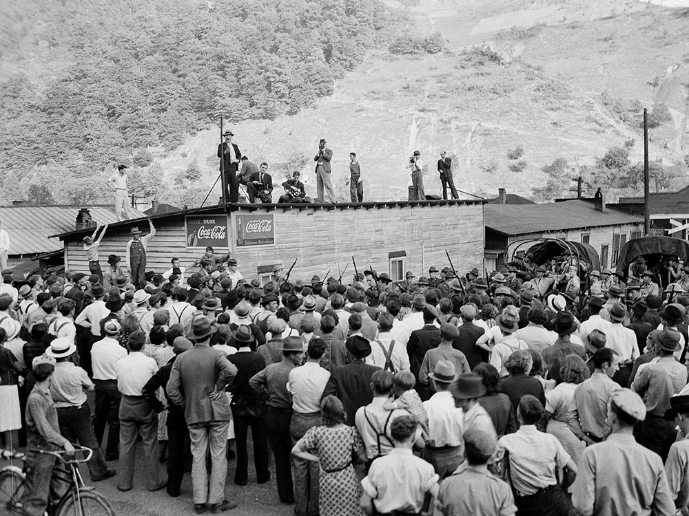 A local preacher on the roof of a building denounces the governor and a local judge for moving troops into Harlan County, Ky., in May 1939 during a coal miners strike. (AP)