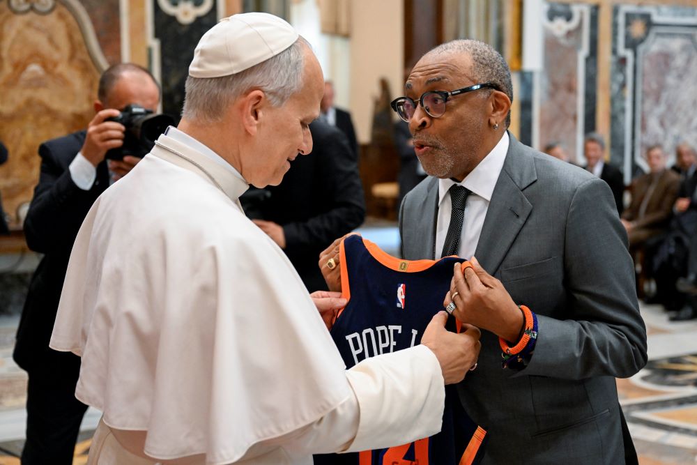 Pope Leo XIV receives a New York Knicks jersey from director Spike Lee during a meeting with film directors and actors.