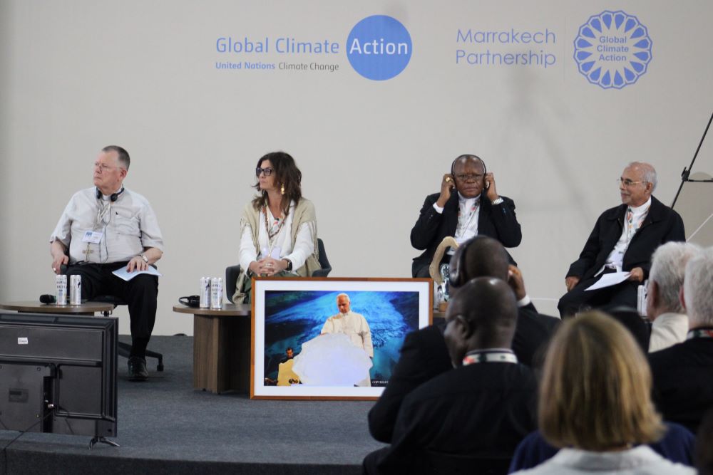 Presenters listen during an event Nov. 13 where Catholic leaders from the Global South discuss a letter demanding climate justice at COP30 in Belém, Brazil. The picture shows Pope Leo blessing a block of ice from a glacier in Greenland during the opening session of an international conference.