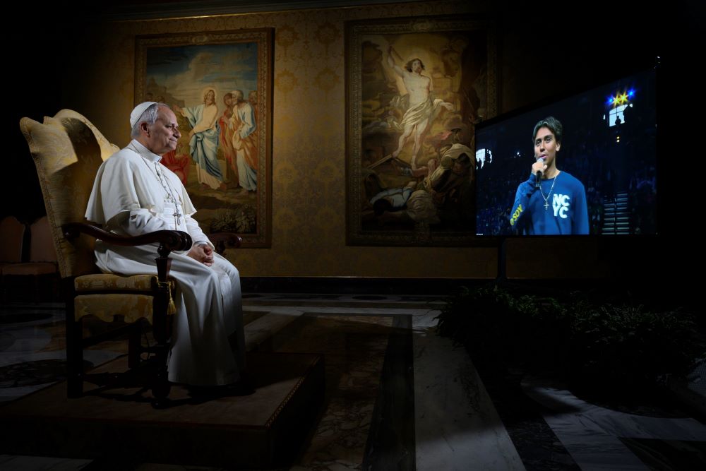 Pope Leo XIV listens to a question from Christopher Pantelakis from the Archdiocese of Las Vegas during a meeting livestreamed from the Vatican.