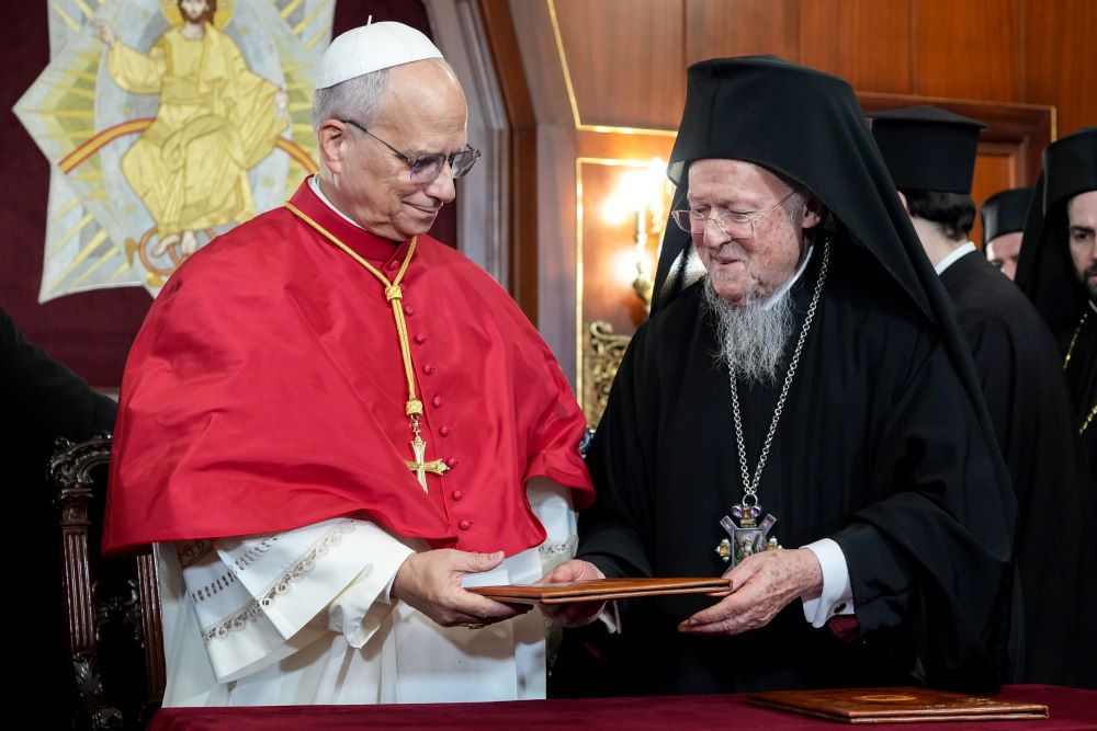 Pope Leo XIV and Orthodox Ecumenical Patriarch Bartholomew of Constantinople hand each other copies of a joint declaration they signed Nov. 29 at the end of a prayer service in the Patriarchal Cathedral of St. George in Istanbul. (CNS/Lola Gomez)
