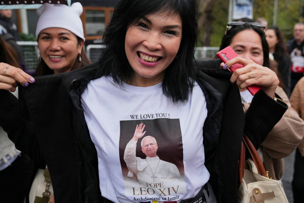 A woman shows her T-shirt as she arrives for a Mass led by Pope Leo XIV at the Volkswagen Arena venue, in Istanbul, Turkey, Nov. 29. (AP/Dilara Acikgoz)