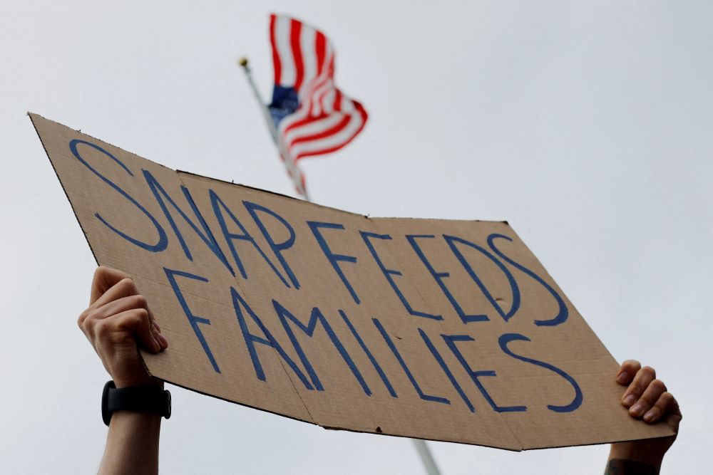 A man holds a sign during "A Rally for SNAP" on the steps of the Massachusetts Statehouse in Boston Oct. 28, ahead of the suspension of federal SNAP food assistance benefits Nov. 1 amid the ongoing U.S. government shutdown. (OSV News photo/Brian Snyder, Reuters)