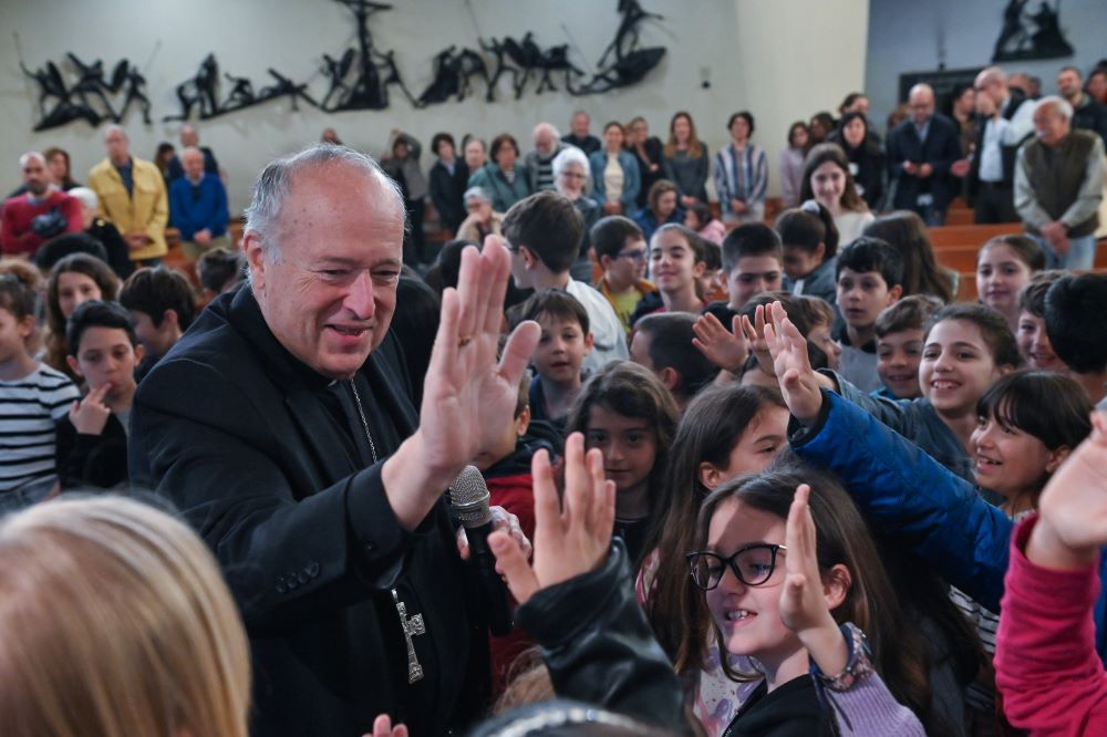 Cardinal Robert McElroy of San Diego exchanges high-fives with young members of the parish of St. Frumentius, his titular church in Rome April 23, 2023. 