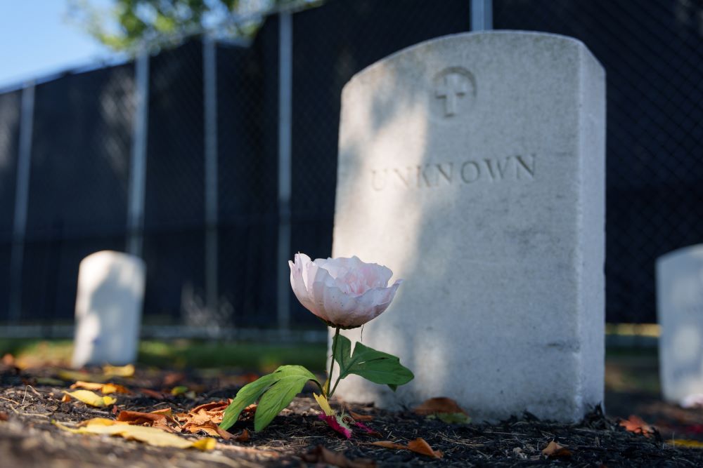 A flower rests in front of a headstone marked as "Unknown" at the Carlisle Barracks Post Cemetery in Carlisle, Pa.