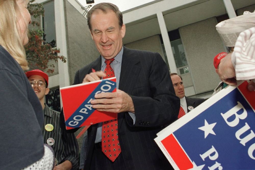 Pat Buchanan autographs a campaign sign for a supporter outside a TV station in Baltimore Oct. 6, 2000. The Reform Party candidate told Catholic News Service that the most important thing the president could do ''is to alter the character of the Supreme Court and reconvert it into a pro-life constitutionalist court.'' (CNS/Nancy Wiechec)