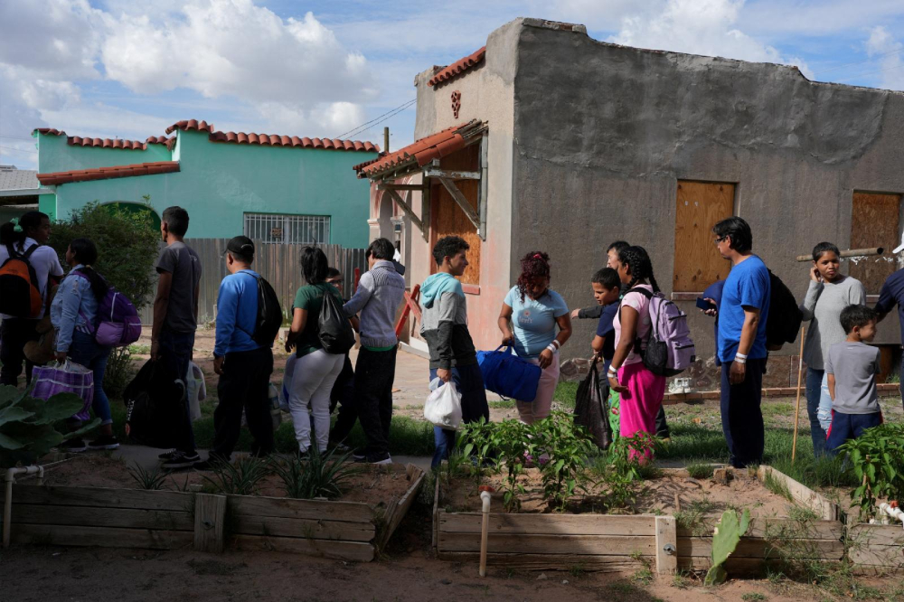 Venezuelan migrants at the Centro de los Trabajadores Agricolas Fronterizos (Border Farmworkers Center) in El Paso, Texas, wait in line to board a bus for Chicago and New York Sept. 2, 2022. (CNS/Reuters/Paul Ratje)