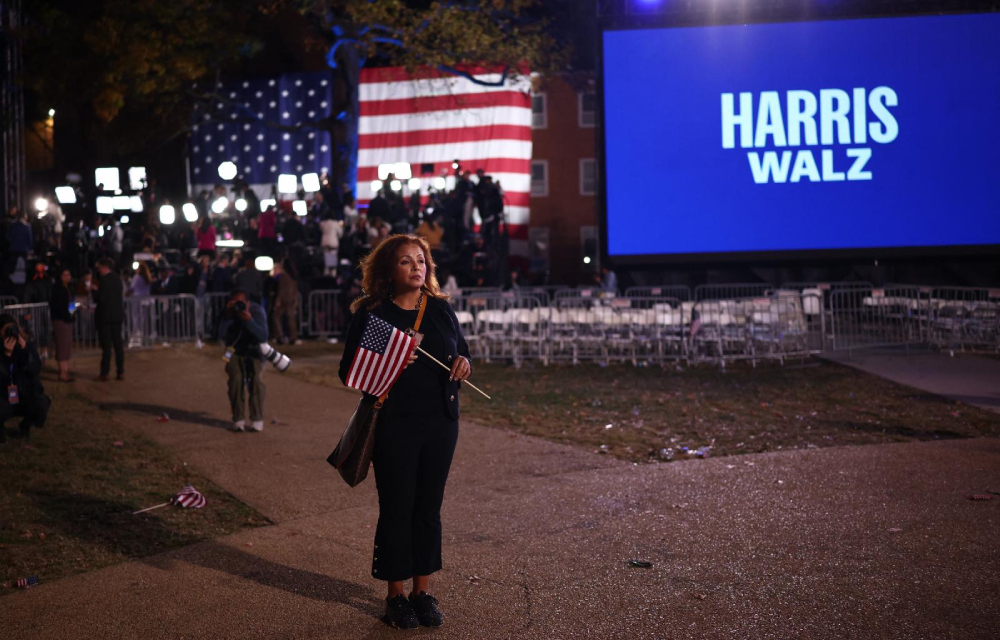 An attendee holds a U.S. flag at the conclusion of an Election Night rally for Democratic presidential nominee U.S. Vice President Kamala Harris at Howard University in Washington Nov. 6, 2024. Harris' Republican rival, Donald Trump, was elected the 47th president of the United States. (OSV News/Reuters/Daniel Cole)