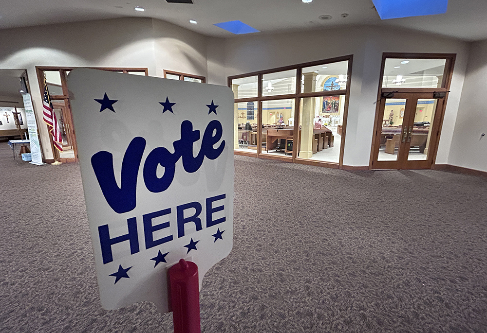 A voting sign is seen in the narthex of St. Elizabeth Ann Seton Church in Fort Wayne, Ind., as the Eucharist is adored in the sanctuary Nov. 6, 2024. (OSV News/Gretchen R. Crowe)