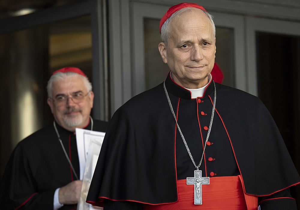 U.S.-born then-Cardinal Robert F. Prevost, then-prefect of the Dicastery for Bishops under Pope Francis, leaves the Vatican Synod Hall April 22, 2025, after the first general congregation of the College of Cardinals. Cardinal Fabio Baggio, undersecretary of the Dicastery for Promoting Integral Human Development, walks out behind him. (CNS/Vatican Media)