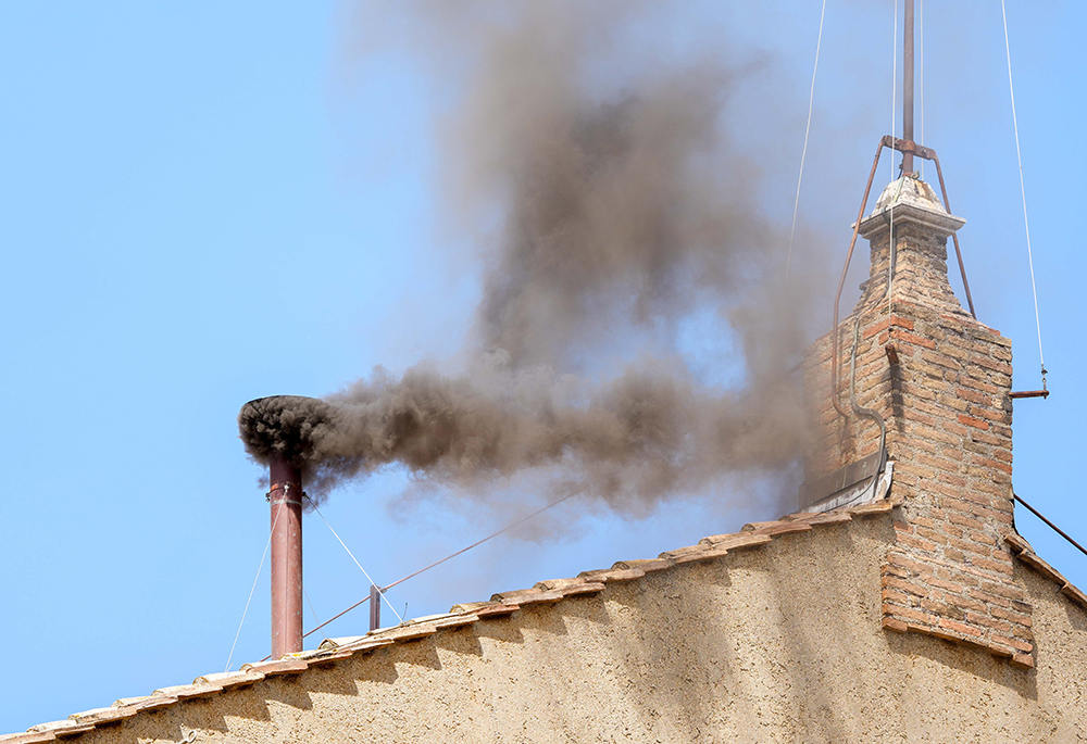 Black smoke billows from the chimney on the Sistine Chapel May 8, 2025, on the second day of the conclave. (CNS/Lola Gomez)