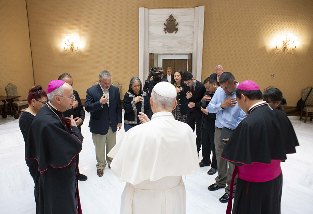Pope Leo XIV blesses Bishop Mark J. Seitz, left, and Auxiliary Bishop Anthony C. Celino of El Paso, right, along with representatives of the Hope Border Institute and others who assist migrants in the United States during a private meeting at the Vatican Oct. 8, 2025. (CNS/Vatican Media)