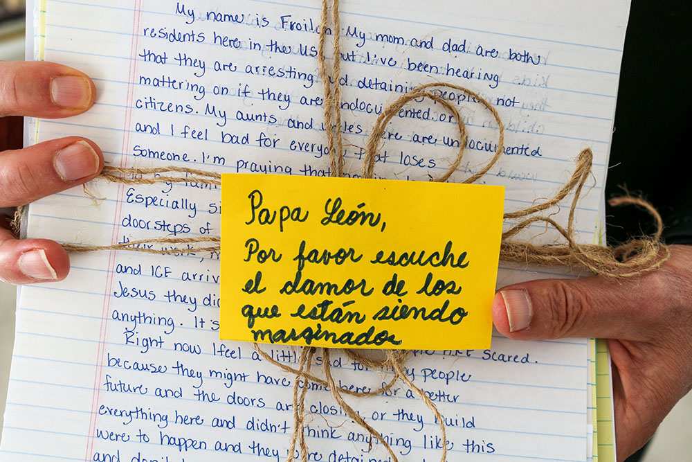 Bishop Mark Seitz of El Paso, Texas, holds a bundle of letters to Pope Leo XIV from migrants in the United States before presenting them to the pope Oct. 8, 2025, during an audience at the Vatican. The note, in Spanish, says, "Pope Leo, please listen to the cry of those who are being marginalized." (CNS/Courtesy of Hope Border Institute)