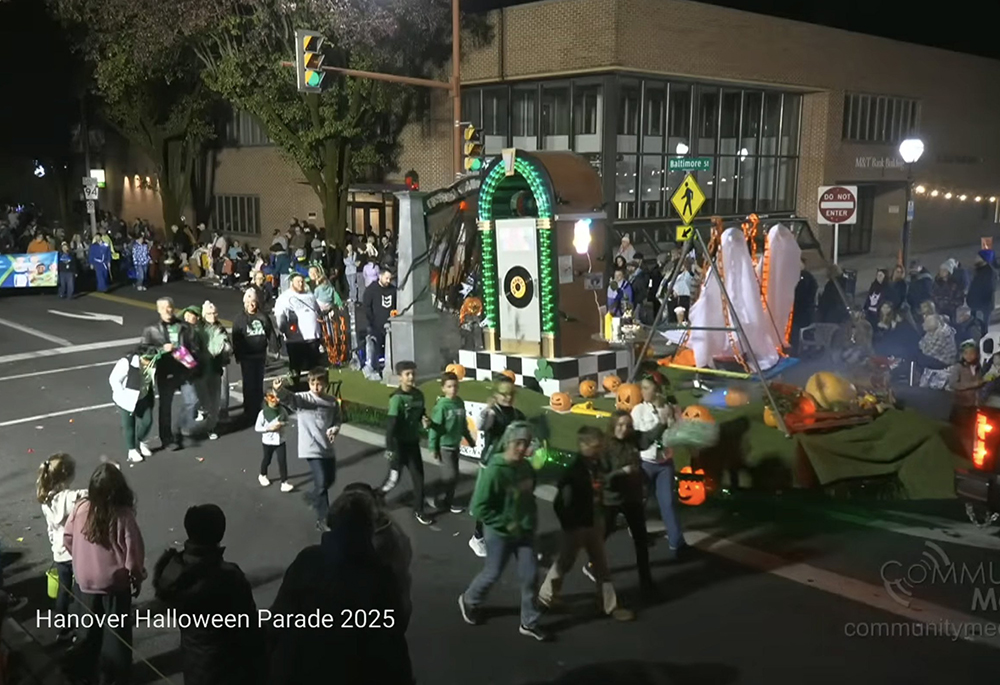 This is a screenshot of a St. Joseph Catholic School float in the Hanover Halloween Parade held Oct. 30, 2025 in Hanover, Pennsylvania. The float includes what appears to be a replica of one of the main gates at Auschwitz concentration camp, including the phrase "Arbeit macht frei." Bishop Timothy C. Senior of the Diocese of Harrisburg apologized for the float in a statement dated Oct. 31, 2025. (OSV News screenshot/Community Media of South Central PA via YouTube)