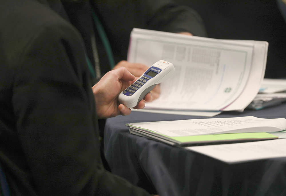 A bishop uses an electronic voting device during a Nov. 14, 2023, session of the fall general assembly of the U.S. Conference of Catholic Bishops in Baltimore. (OSV News photo/Bob Roller)
