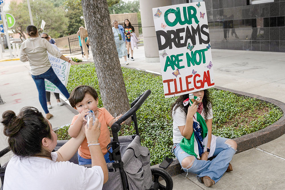 Brendaletzy Lopez, 30, a recipient of the Deferred Action for Childhood Arrivals policy, holds a placard that reads, "Our dreams are not illegal," ahead of a hearing on the DACA program, outside the federal courthouse in Houston June 1, 2023. Texas Catholic bishops say a federal court is poised to change the lawful presence of an estimated 90,000 DACA recipients in Texas to unlawful. (OSV News/Reuters/Adrees Latif)