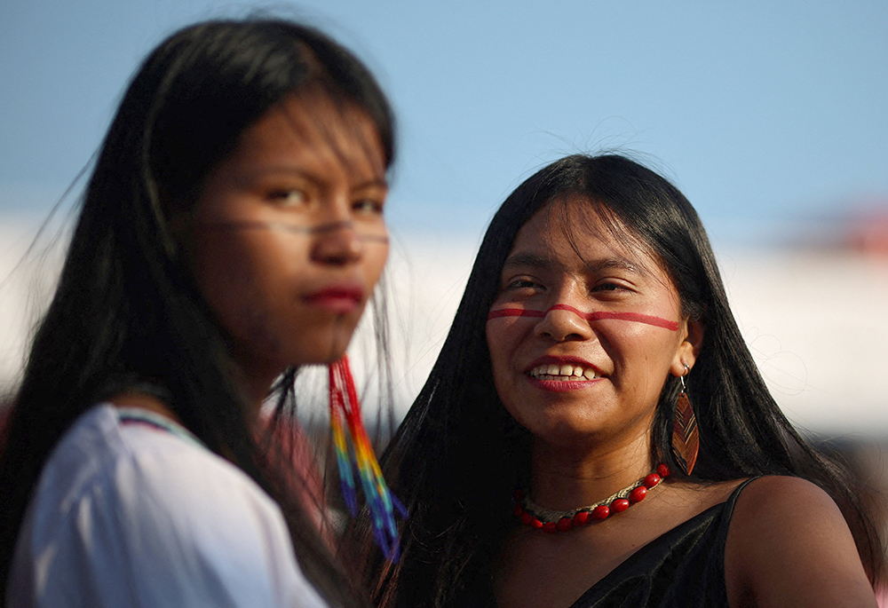 Women look on after a flotilla carrying Indigenous representatives from across Latin America arrived in Belém Nov. 9, 2025, ahead of the U.N. climate change conference, or COP30, in Brazil. A delegation of cardinals, bishops and lay activists gives the Brazil church a strong presence at COP30, taking place Nov. 10-21 in Belém. (OSV News/Reuters/Adriano Machado)
