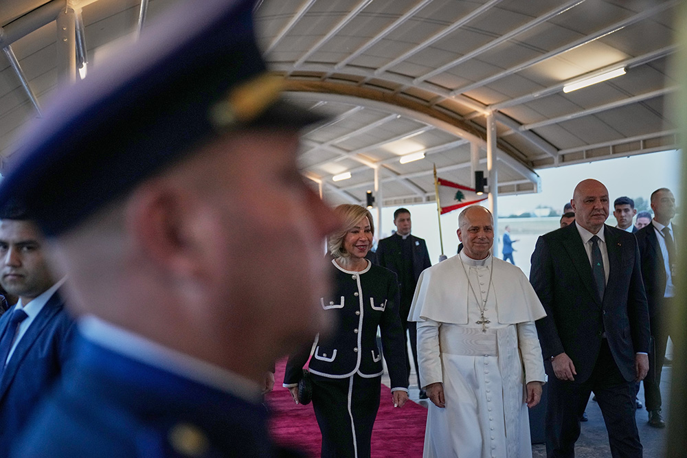 Pope Leo XIV, center right, is escorted by Lebanese President Joseph Aoun, right, and First Lady Nehmat Aoun after his arrival at Beirut International Airport in Beirut, Lebanon on Nov. 30, 2025. (AP Photo/Hussein Malla)