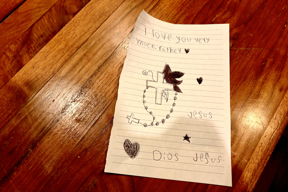 A card written by a young Venezuelan couple's 8-year-old son for Fr. Dennis Berry on Oct. 26, 2025, the day took the family to do laundry at the rectory at St. James Parish. (NCR photo/Camillo Barone)
