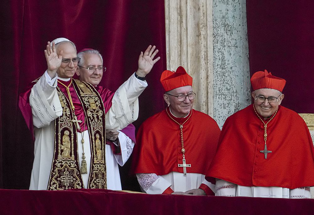 Newly elected Pope Leo XIV, left, formerly Cardinal Robert Francis Prevost, appears with, from left, Archbishop Diego Giovanni Ravelli, master of ceremonies; Cardinal Pietro Parolin; and Bosnian Cardinal Vinko Puljić on the central loggia of St. Peter's Basilica at the Vatican, shortly after he was elected pope, Thursday, May 8, 2025. (AP photo/Domenico Stinellis)