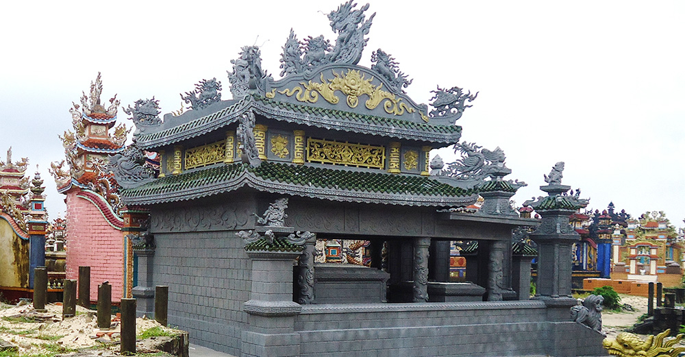 Built in 2018, this 30-square-meter tomb — the smallest in the cemetery — cost 450 million dong (US$18,000). Its modest scale contrasts sharply with the monumental tombs rising around it. (Joachim Pham)