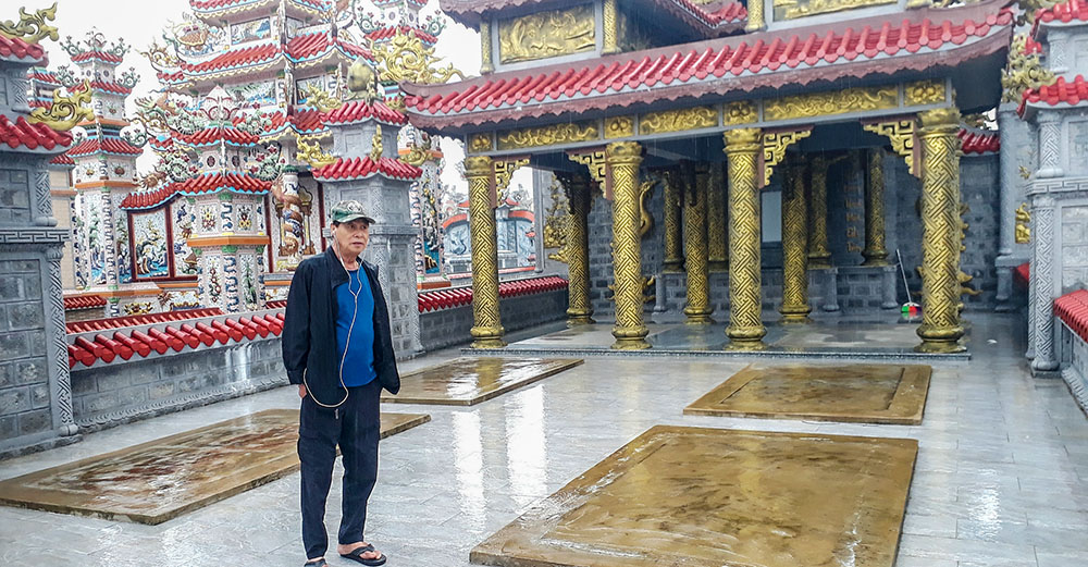 Le Tan Tha stands inside his family's newly built 100-square-meter tomb on Oct. 25, 2025. The resting place is designed for him, his wife and their two children — all still living — reflecting a tradition of preparing one's final home in advance. (Joachim Pham)