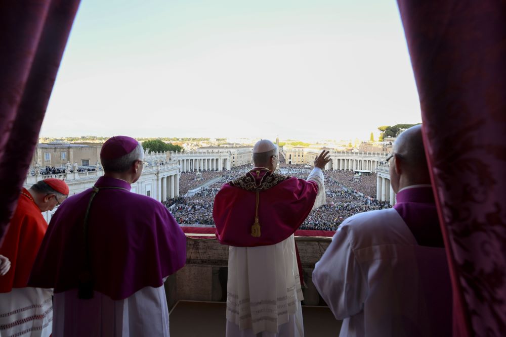Pope Leo XIV, the former Cardinal Robert Francis Prevost, waves after walking onto the central balcony of St. Peter's Basilica at the Vatican May 8, following his election during the conclave. 