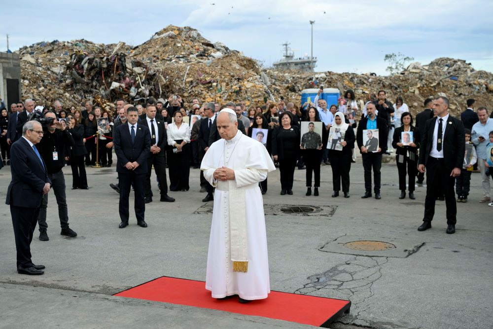 Standing amid the rubble and with the loved ones of people killed behind him, Pope Leo XIV prays at a memorial marking the site of a deadly explosion in 2020 at the port in Beirut Dec. 2.