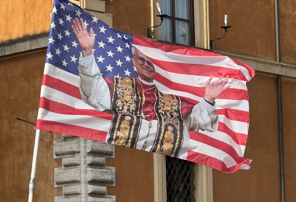 A U.S. flag with a photo of Pope Leo XIV is seen on the Via della Conciliazione near the Vatican June 17.