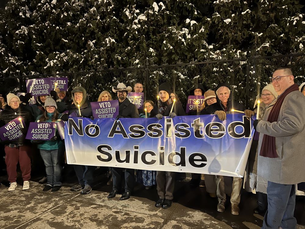 Opponents of New York state's proposed assisted suicide bill stand outside the governor's mansion in Albany, Dec. 3 for a candlelight vigil urging for Gov. Kathy Hochul to veto the bill passed by the Legislature. 