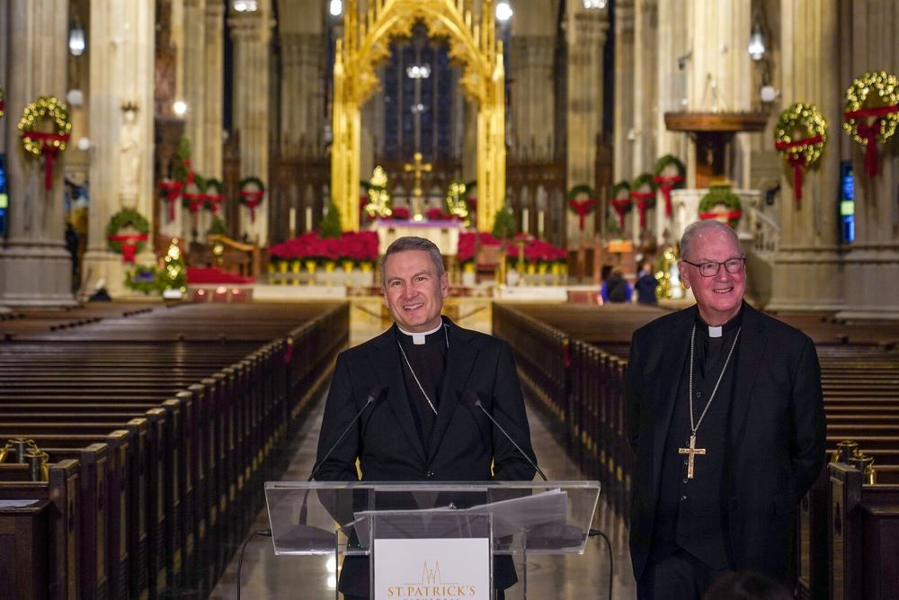 New York Archbishop Timothy Dolan, right, welcomes Bishop Ronald Hicks during a news conference at St. Patrick's Cathedral, Dec.18. in New York. 