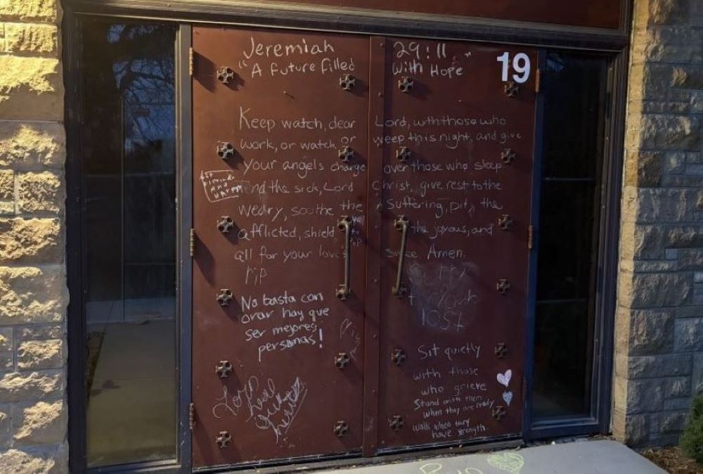 The side door of Annunciation Catholic Church is covered with messages commemorating the victims. (NCR photo/Camillo Barone)
