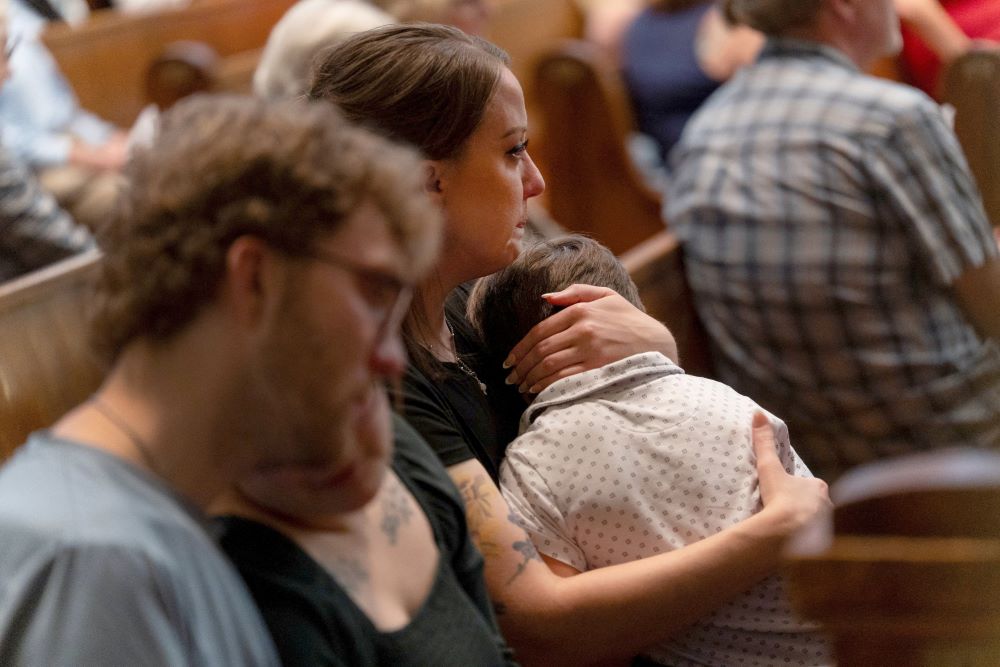 Mary Perez embraces her son, Felix, a first-grade student at Annunciation Catholic School in Minneapolis, during an interfaith prayer service at the Basilica of St. Mary in Minneapolis Aug. 28.