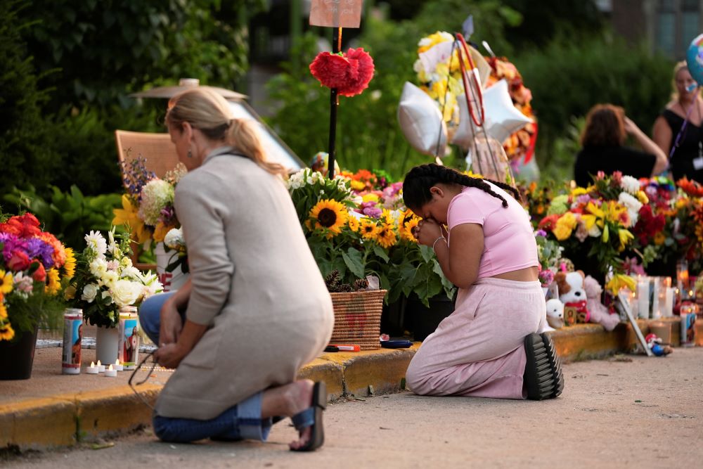 People pray at a memorial at Annunciation Catholic Church Aug. 28 in Minneapolis.