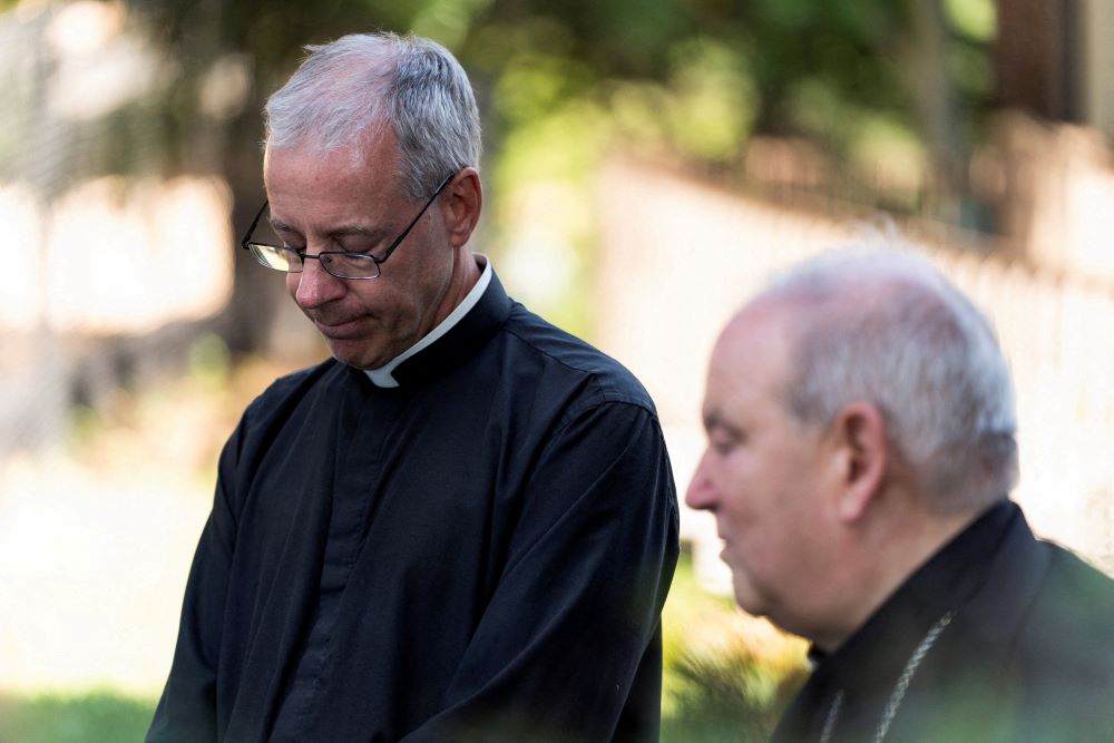 Annunciation Church pastor Fr. Dennis Zehren, left, becomes emotional as he speaks to the media alongside St. Paul and Minneapolis Archbishop Bernard Hebda Aug. 30 about the Aug. 27 shooting at the church. 