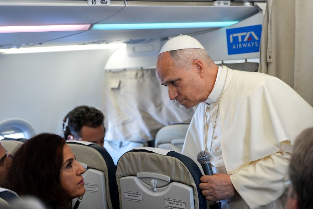 Pope Leo XIV listens to a question from a journalist during a news conference aboard his flight from Turkey to Lebanon Nov. 30. 