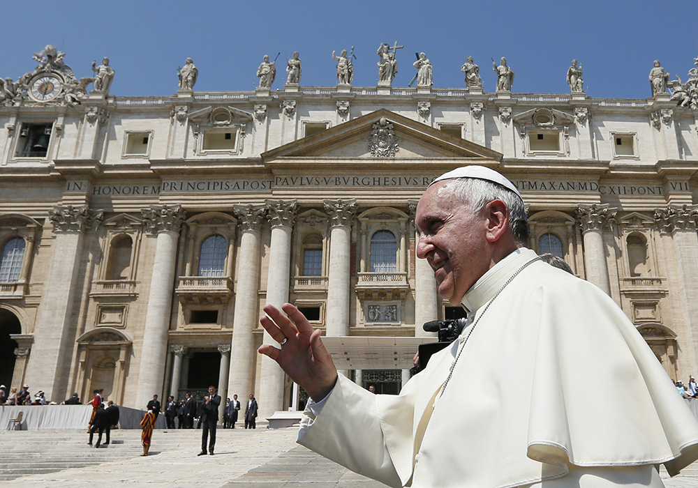 Pope Francis greets the crowd as he leaves his general audience in St. Peter's Square at the Vatican June 11, 2014. (CNS/Paul Haring)